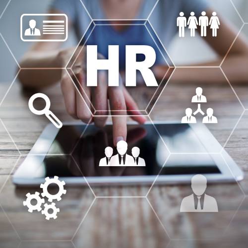 A person tapping a tablet on a table. A graphic above the tablet shows different HR icons and the word "HR" in white letters.